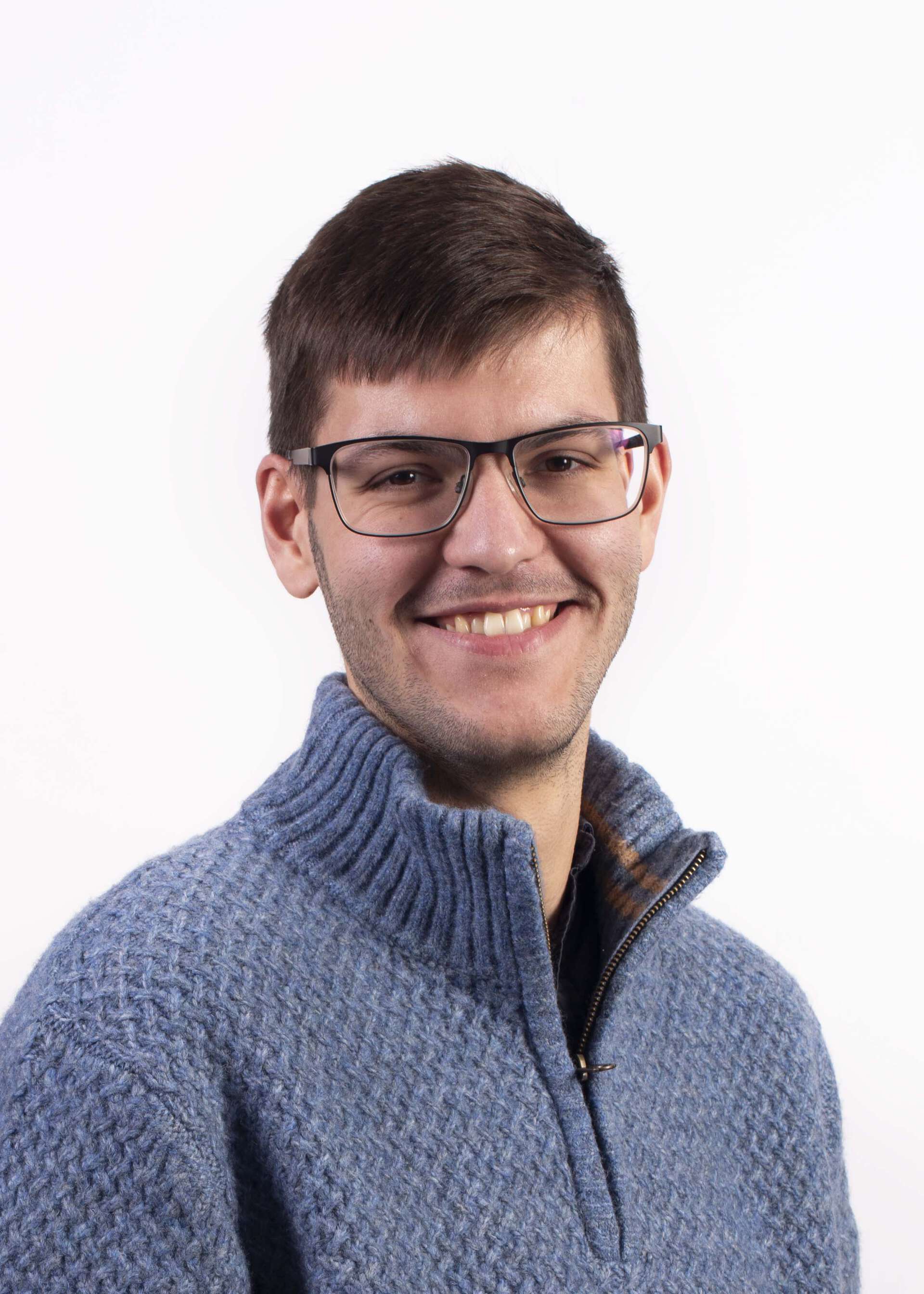 Photo of Jordan Richards, a white man with glasses and short hair