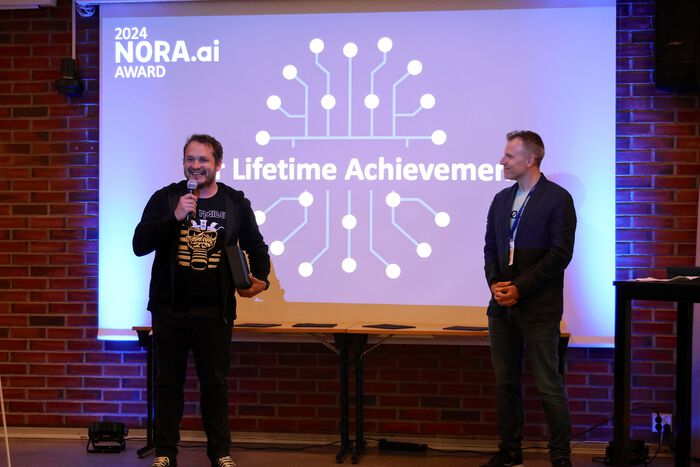 Two men on stage: Michael Riegler and Stefano Nichele, the conference host
