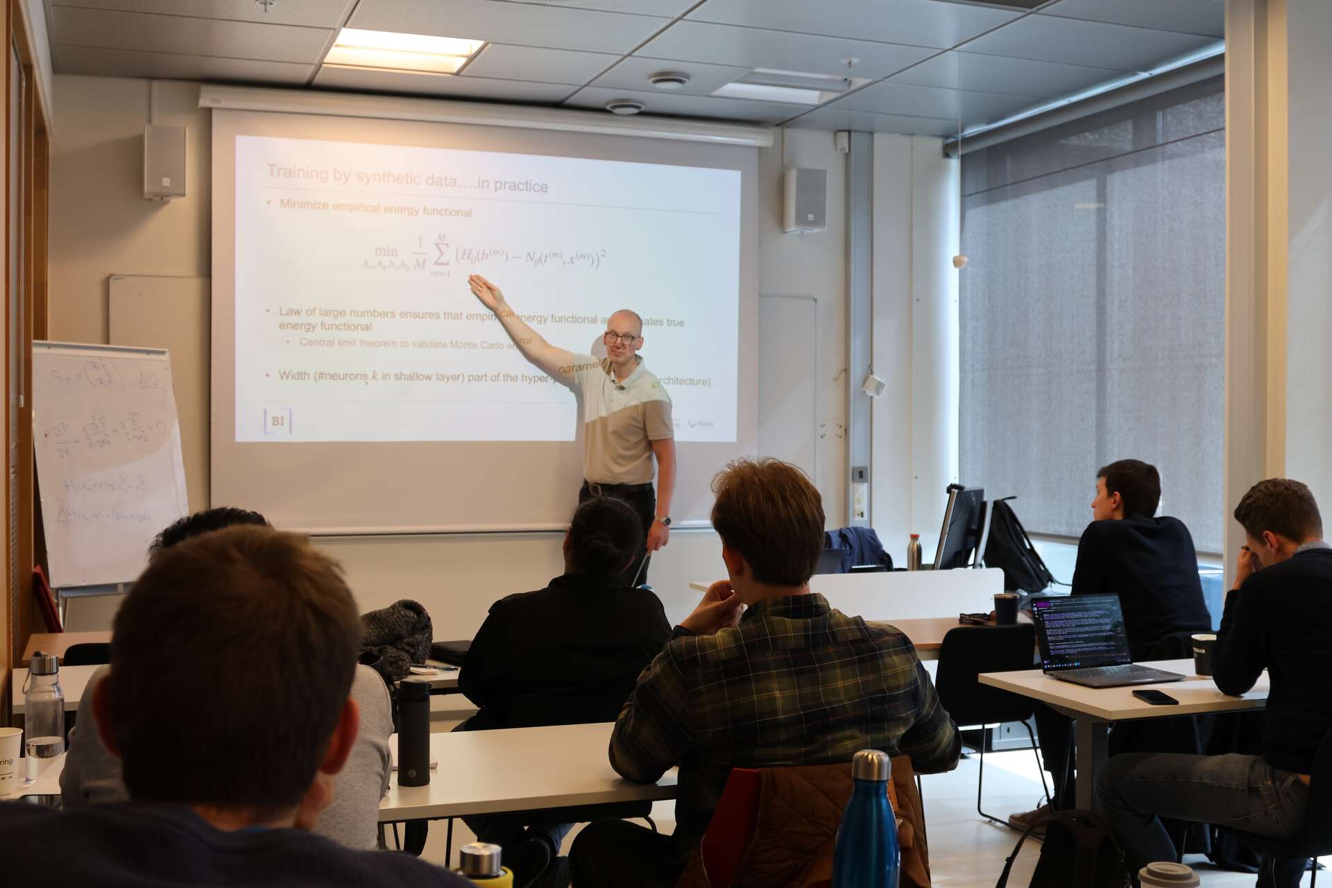 Professor in front of a screen, students in the classroom