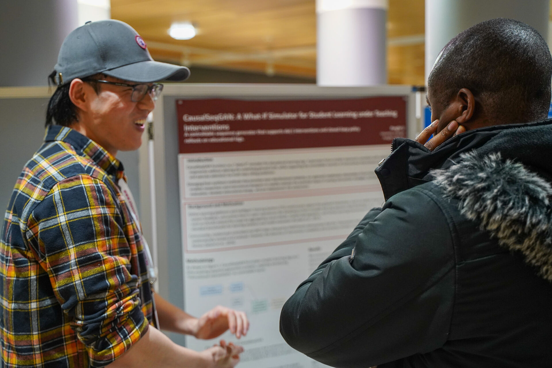Two people at the poster session