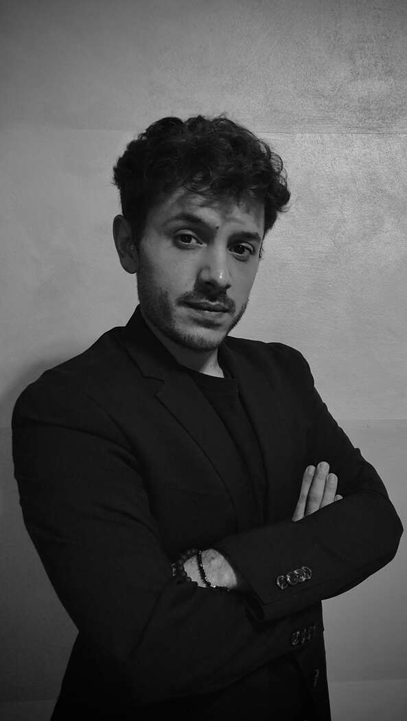Mattia Tamiazzo. He has short hair and arms crossed