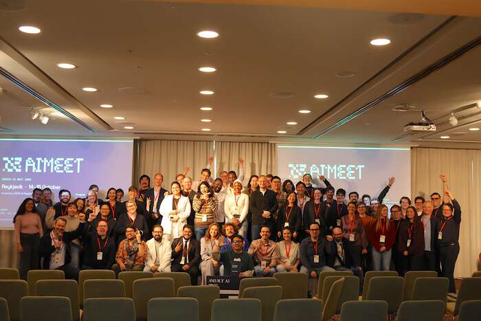 Group of people standing in front of screens