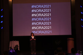 Coat ,Chair ,Projection screen ,Public speaking ,Suit.