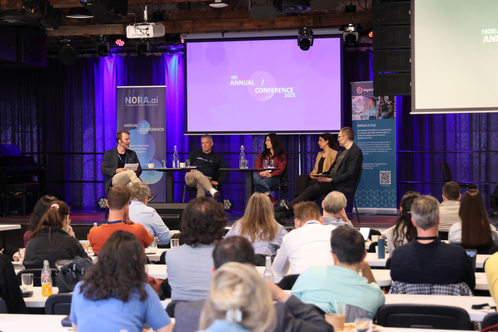 Photo of panel talking in front of an audience