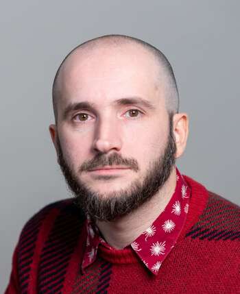 Man wearing a read sweater