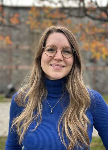 Woman with glasses and long hair, out in nature